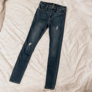 High rise women’s lightly distressed dark wash blue jeans. Size 7 Long